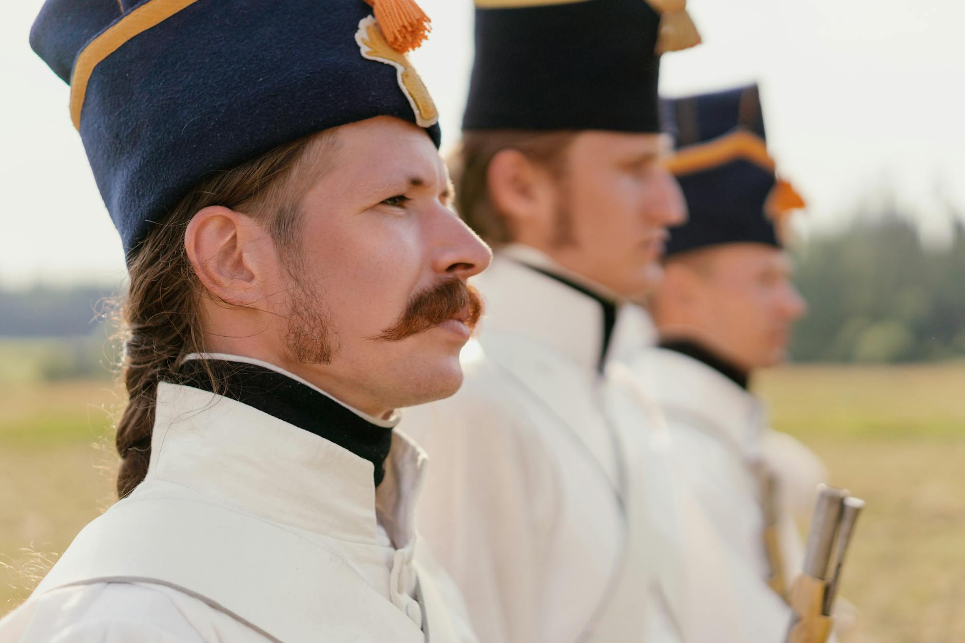 Men in 1700s military uniforms.