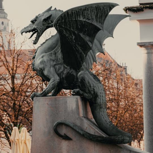 A statue of the Green Dragon of Ljubljana facing left.