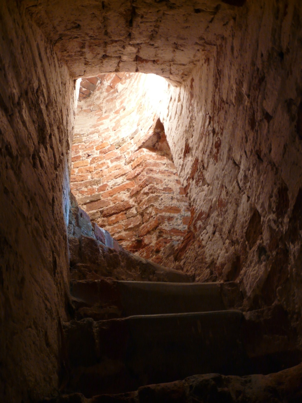 Stairs leading up from a brick vault.