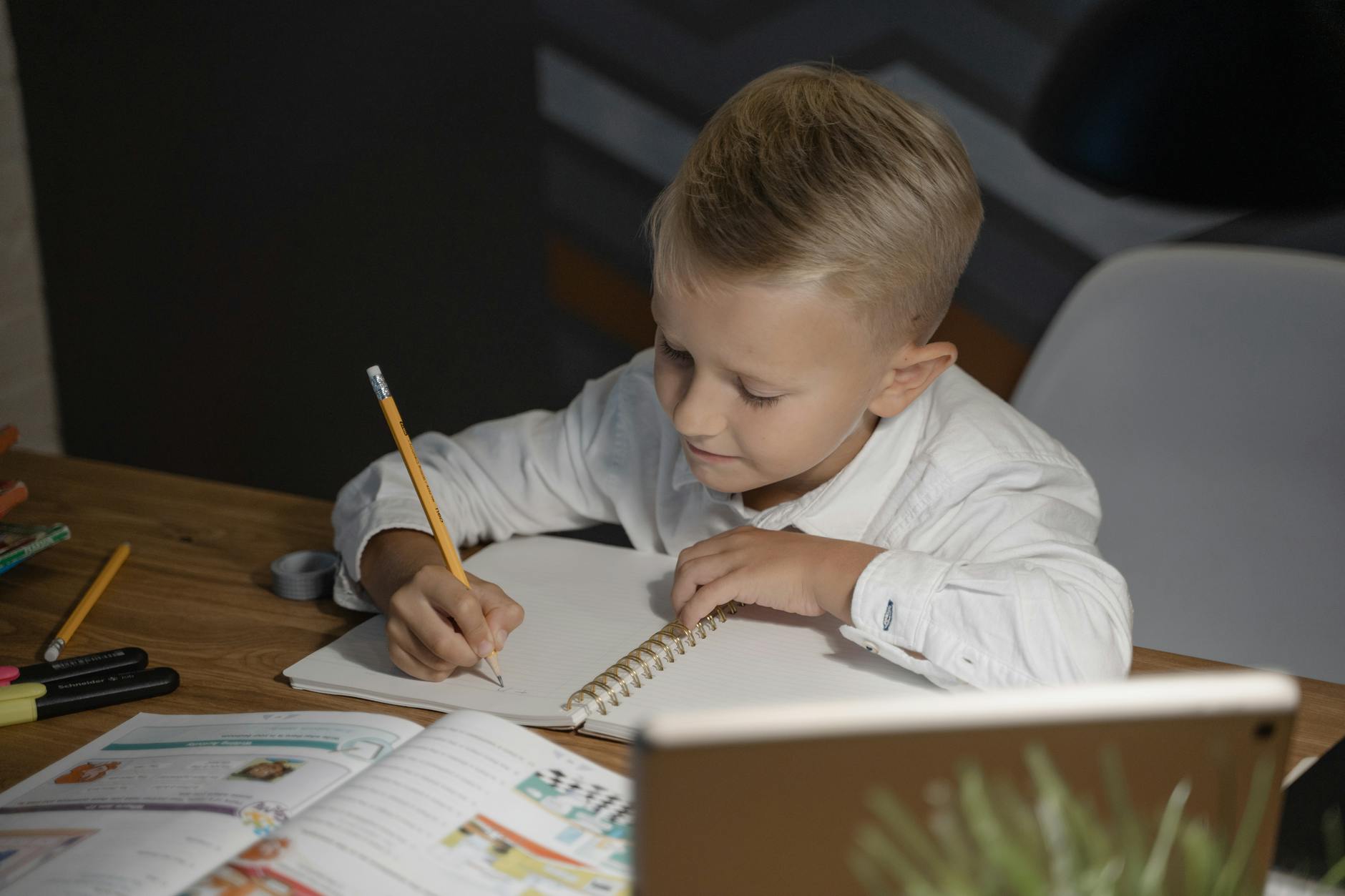 A young boy writing.