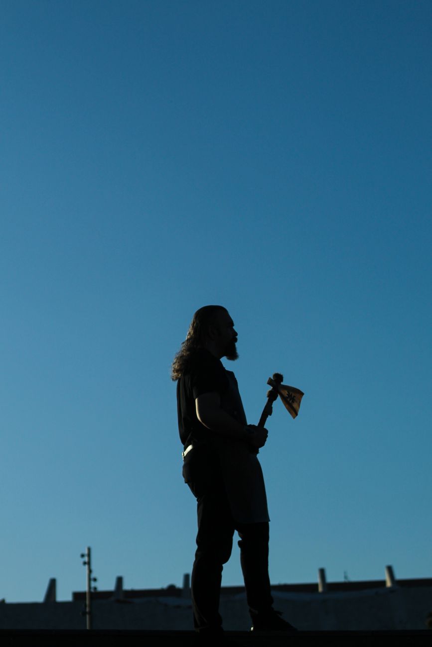 A silhouette of a man with an axe.