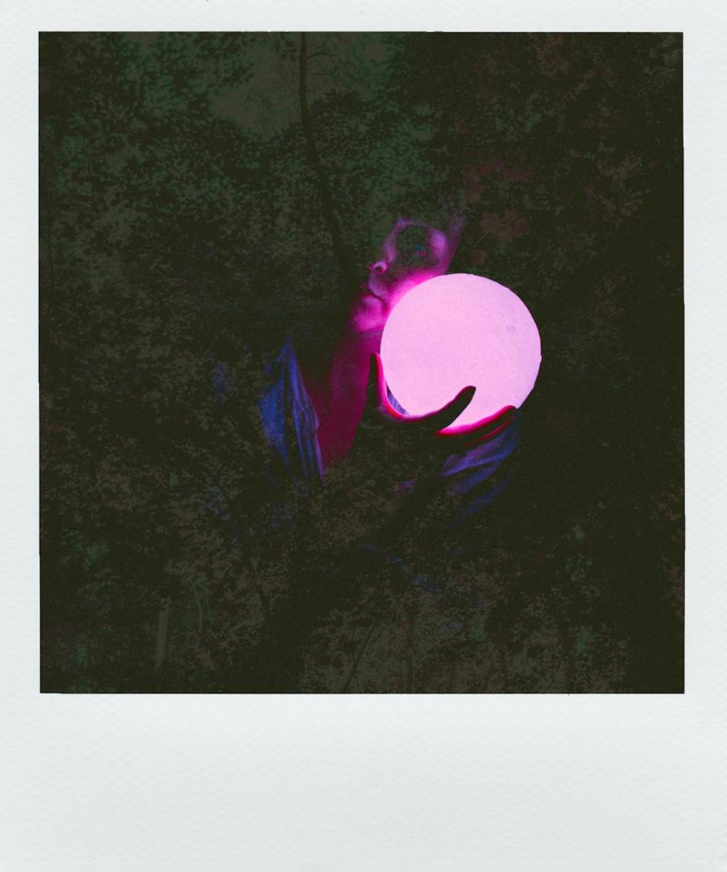 A woman holding a purple orb.