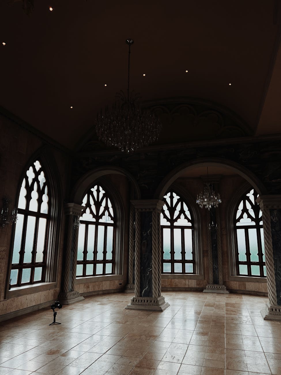 A room in a castle with large, ornate windows.
