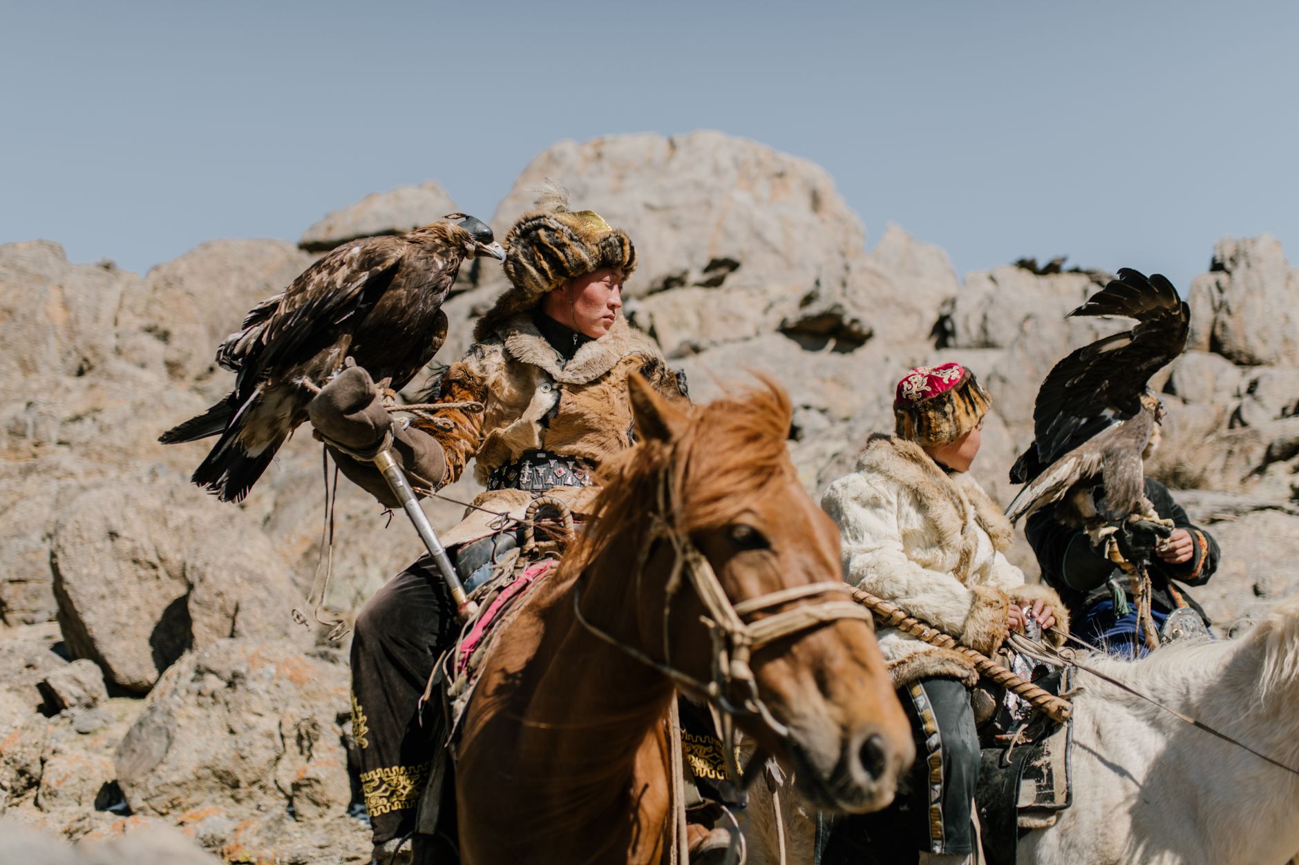 Mongolian falconers on horses.